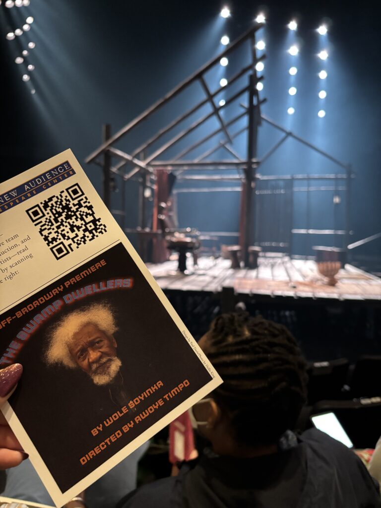 a program is held up in front of a set