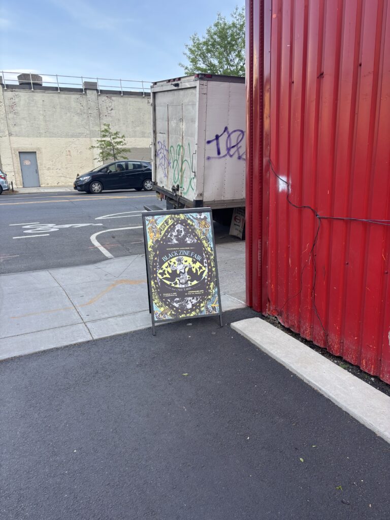 A standing floor sign sits outside on the pavement.