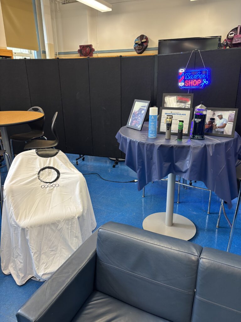 A barber chair next to a table of barber supplies.