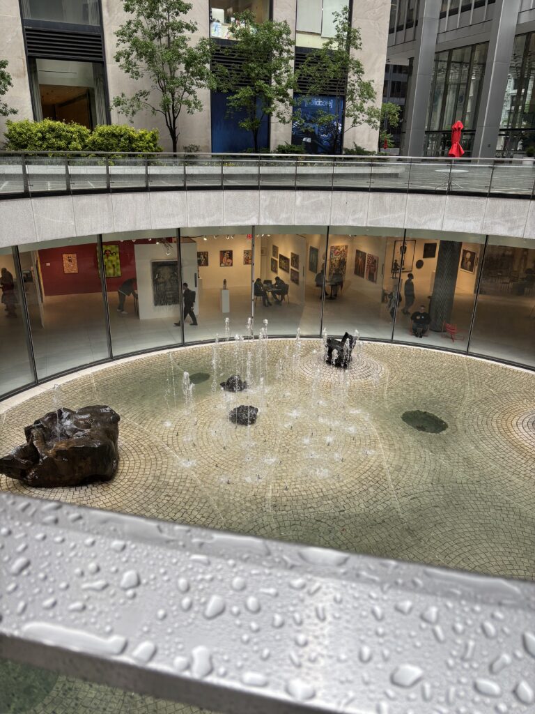 a plaza opens to create an underground venue with a round skylight