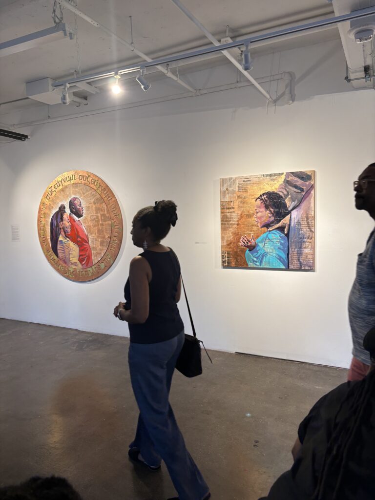 people walk by artwork