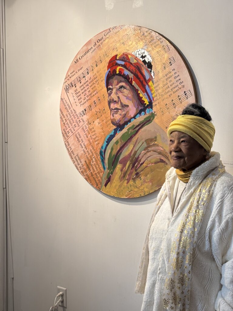 woman stands with artwork