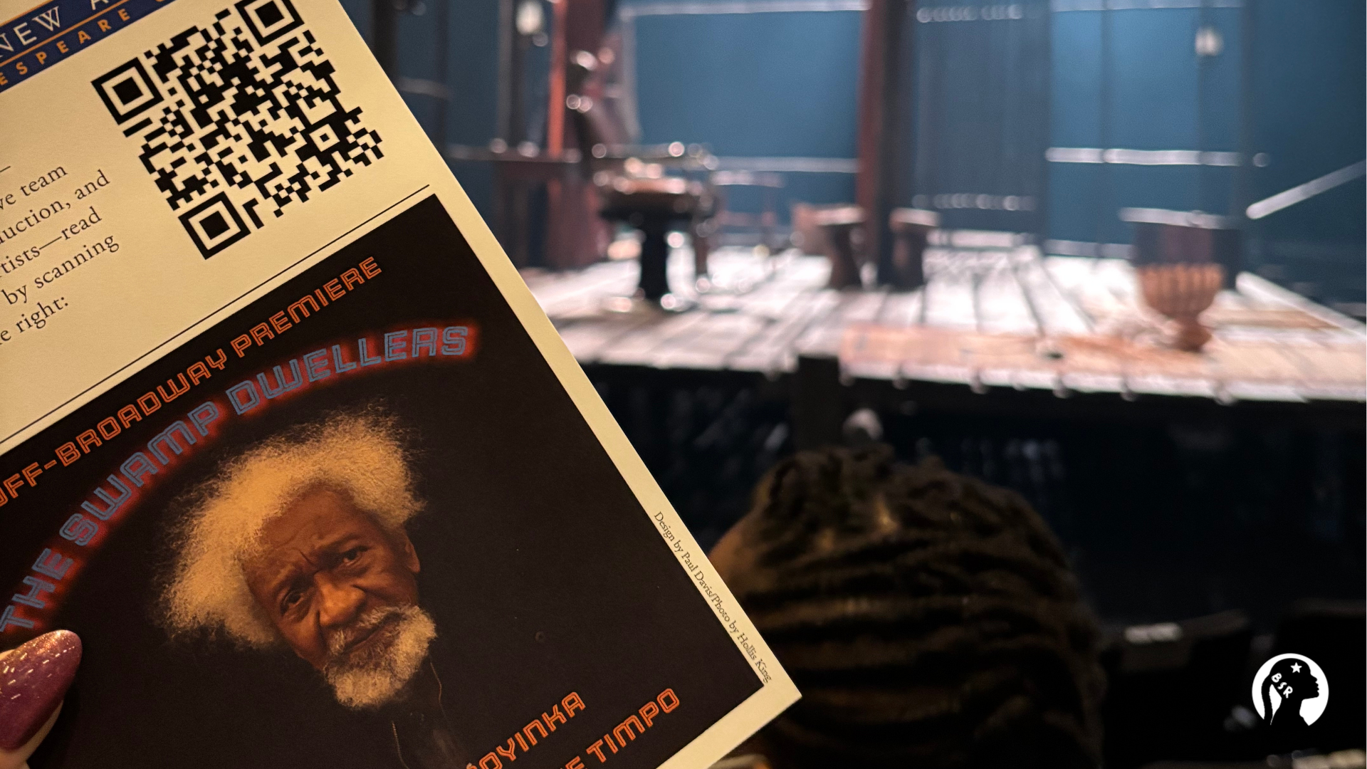 a theatre program in front of a stage