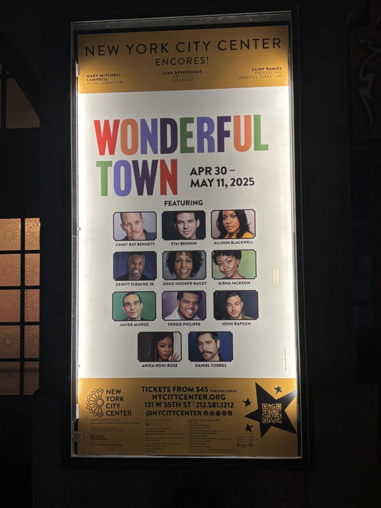 an illuminated poster shows the cast of Wonderful Town