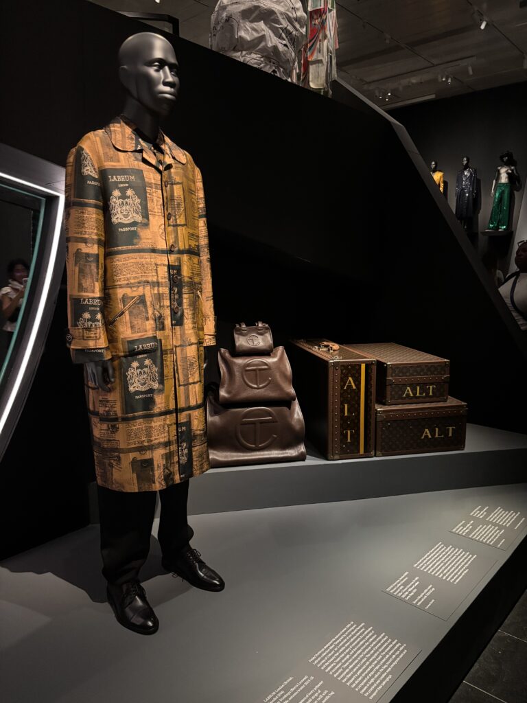 clothing on a mannequin next to luggage