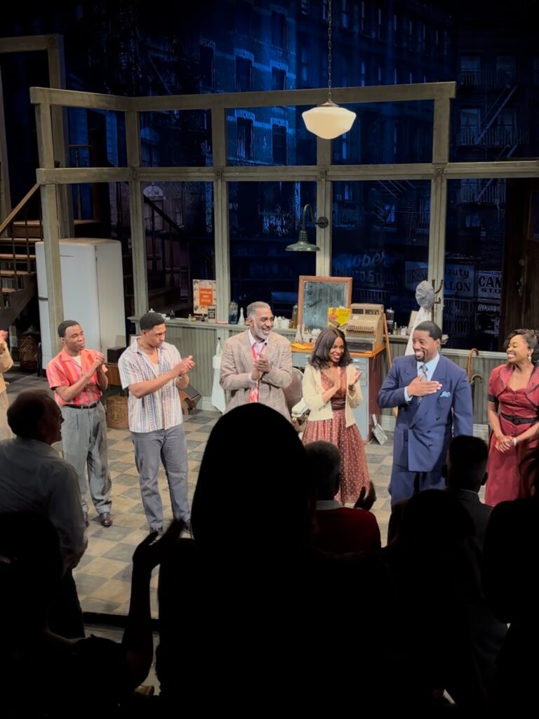 Actors stand on stage