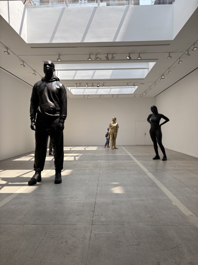 statues stand in a gallery