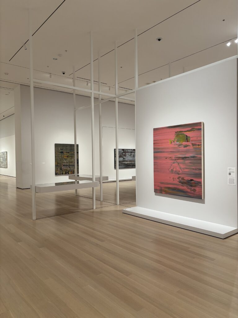 art hangs on the walls of a gallery