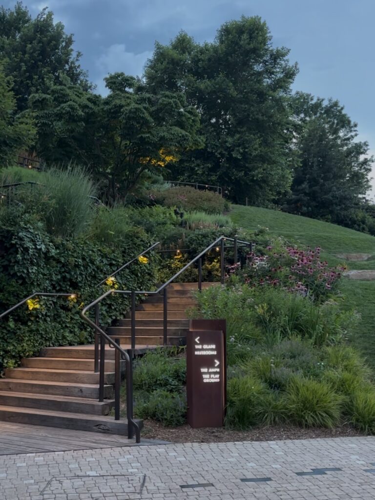 Trees, shrubs, and grasses line a stone staircase on The Little Island