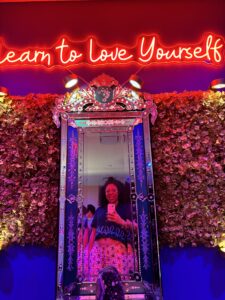 A woman takes a selfie in a mirror