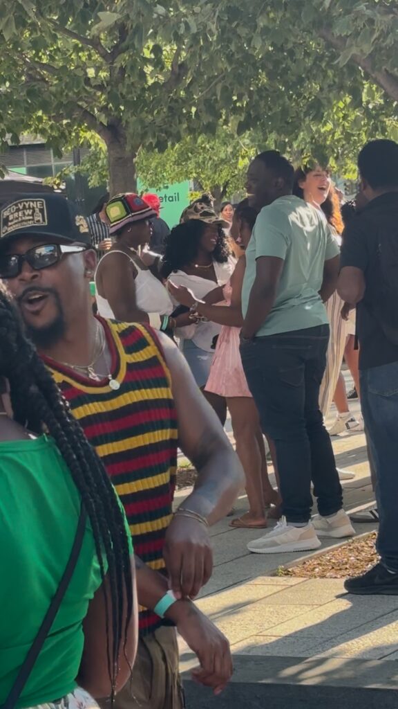 Young, black people in unique outfits talk to each other